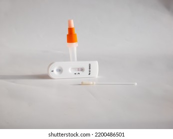 SARS-CoV-2 Antigen Rapid Test (Nasal Swab) For Self Testing With Used Sterile Swab And Test Cassette With Negative Result Isolated On White In Bright Sunlight. COVID-19 Ag.