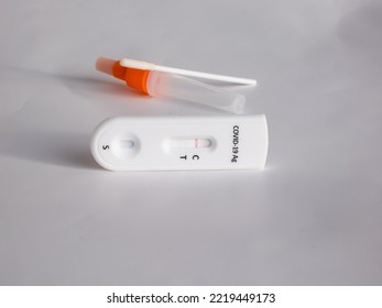 SARS-CoV-2 Antigen Rapid Test (Nasal Swab) For Self Testing With Use Sterile Swab And Test Cassette With Negative Result Isolated On White In Bright Sunlight. COVID-19 Ag.