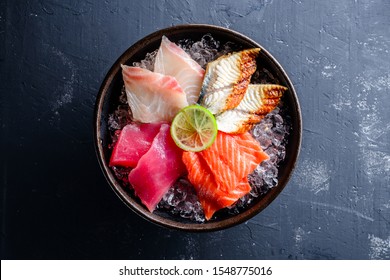 Sashimi Japanese Food, Pieces Of Tuna, Salmon, Smoked Eel With Ice In Bowl. Fish Slices Top View