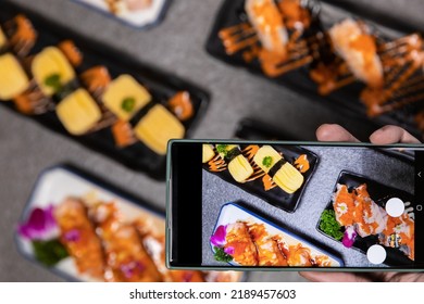 Sashimi Sushi Set With Soy On Black Background.Assorted Sushi Set Served On Dark Stone Slate Background. Mobile Phone Camera Top View.