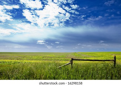 A Saskatchewan Prairie Landscape With Blue Sky And Field