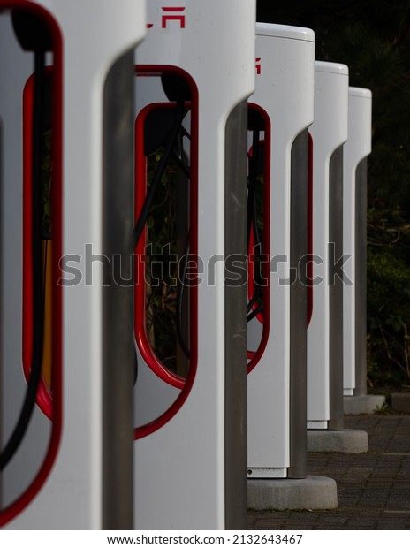SASSENHEIM, NETHERLANDS - Feb 06,\
2022: A vertical shot of a Tesla charger station,\
Netherlands