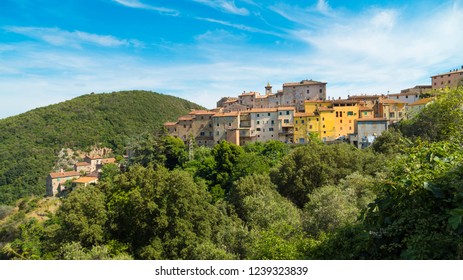 Sassetta, Livorno, Tuscany, Italy - 25 June 2018. View Of The Old City Buildings And Mountains