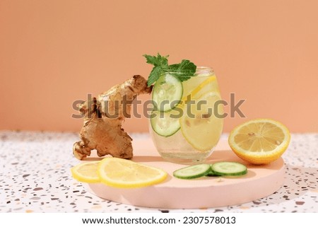 Sassi Drink Diet Healthy Water with Sliced Cucumber, Lemon, and Ginger. Magic Slimming Drink. On Orange Background, Copy Space for Text Imagine de stoc © 