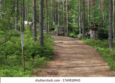 Sastamala, Finland - July 4 2020: Documentary Of Everyday Life And Place. Peaceful Outdoor Scene - Wild Woods Nature. Peaceful Outdoor Woods Nature. Road In The Woods.