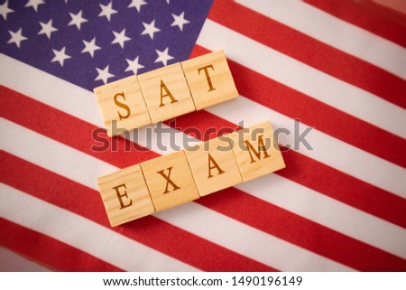 SAT Exam in Wooden block letters on US flag