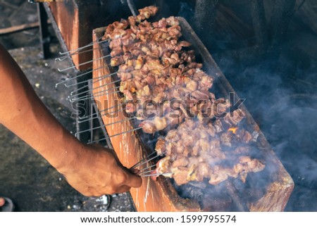 Satay Klatak making process on charcoal grill. Sate klathak is a unique goat satay or mutton satay dish, originally from Yogyakarta, Indonesia.