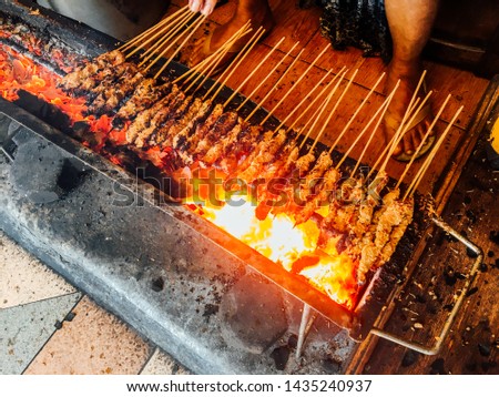 Similar – Man cooking on a barbecue