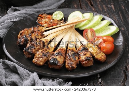 Sate lilit is a satay variant in Indonesia, originating from Balinese cuisine. This satay is made from fish, chicken, beef, or even turtle meat, which is then mixed with grated coconut, thick coconut 
