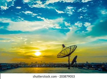 Satelite Dishes With Sunset And City Background