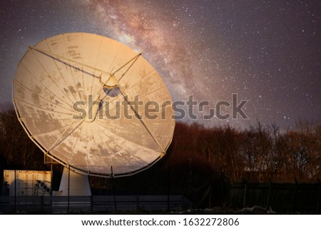 Satellite dish large and antenna for communication and mobile technology network at night starry sky showing the galaxy stars