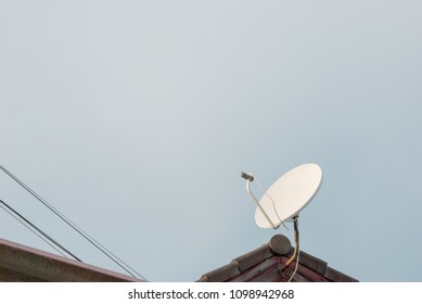 Satellite dish on blue sky background 