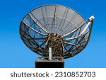 Satellite dish over blue sky. Television, radio and network concept