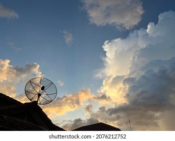 satellite dish in silhouette and sunset sky in background. - Shutterstock ID 2076212752