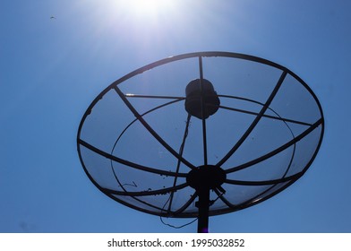 Satellite Dish For Watching Satellite TV Programs. Clear Sky Background From Sun Rays.