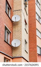 Satellite dishes on the facade of a multi-storey residential building. Satellite TV and communication. Installation of satellite equipment