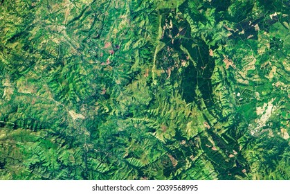 Satellite Photo Of Forest Or Jungle, Summer Topography. Aerial View Of Green Land As Abstract Map Texture Background. Nature Pattern In Satellite Picture. Elements Of This Image Furnished By NASA.