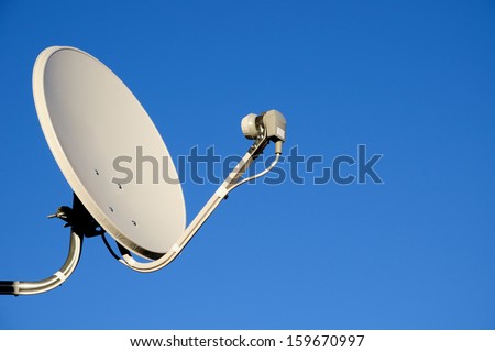 Satellite TV antenna on blue sky background