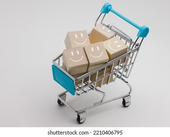 Satisfaction Concept, Product Marketing Review, Shopping Cart And Wood Block With Smiley Face.