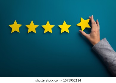Satisfaction concept. Woman hand giving five star rating on green background, copy space