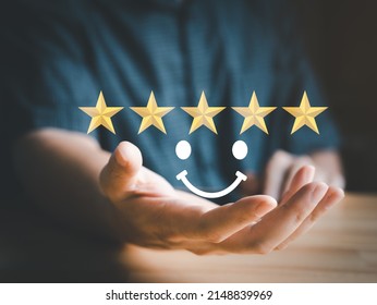 Satisfaction rating, ranking or feedback by hand hold happy, smiley or enjoin face and gold stars, customer satisfy survey. Satisfaction rating concept. - Shutterstock ID 2148839969