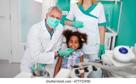Satisfied Black Child With Dentist After Treatment
