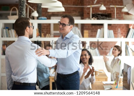 Satisfied businessman handshake male employee congratulating with success or achievement, happy boss shake hand of intern welcoming to team, CEO greeting worker with promotion. Reward concept