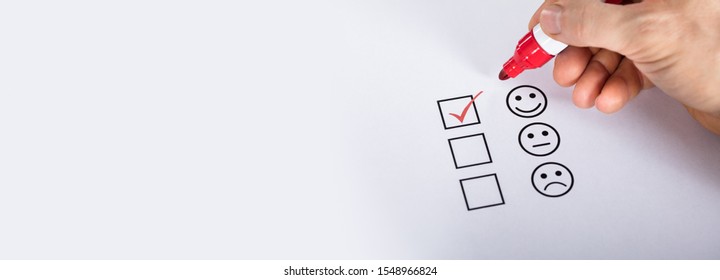 Satisfied Customer Putting Check Mark On Quality Service Survey Checklist Next To Drawn Happy Face