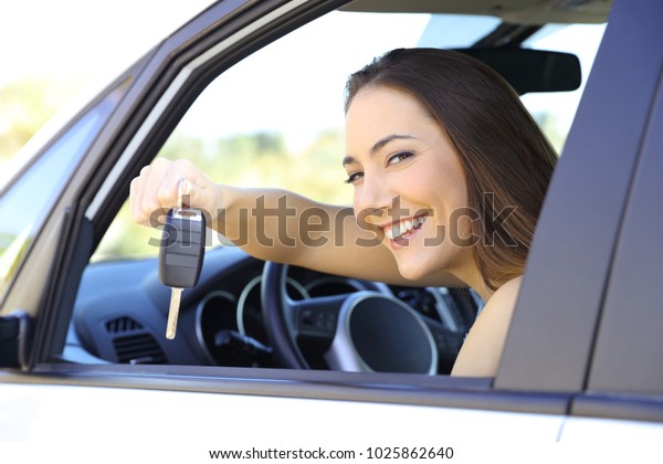 Satisfied driver\
showing the car keys to\
camera