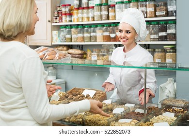 Satisfied European Mature Woman Buying Different Nuts In Local Supermarket