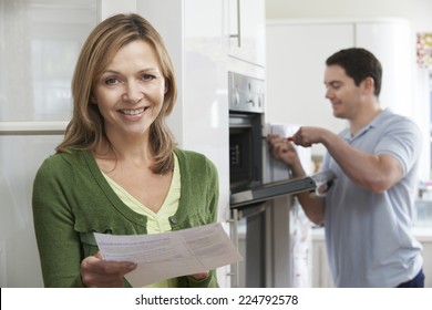 Satisfied Female Customer With Oven Repair Bill