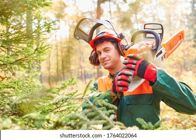 Satisfied forest worker or lumberjack with chainsaw and in protective clothing - Powered by Shutterstock