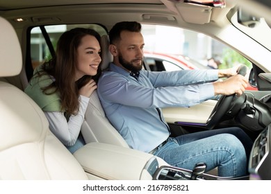 Satisfied Married Couple In A New Car Exploring The Features Of The Interior