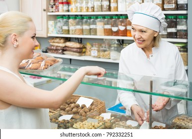 Satisfied Mature Woman Buying Different Nuts In Local Supermarket