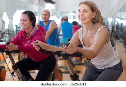 Satisfied Older People Do Sports On Exercise Bikes