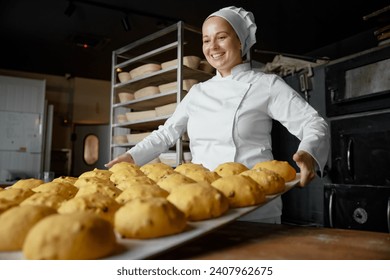 Satisfied positive woman baker in uniform at craft bakery workshop - Powered by Shutterstock