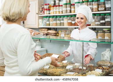 Satisfied Russian Mature Woman Buying Different Nuts In Local Supermarket