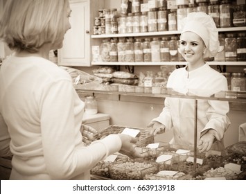 Satisfied Russian Mature Woman Buying Different Nuts In Local Supermarket