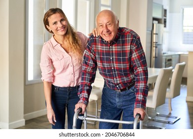 Satisfied senior with walker learning to walk at home with the support of his daughter - Powered by Shutterstock