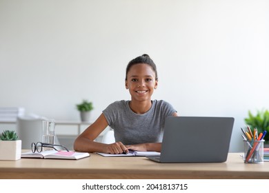 Satisfied Smart Teenager Afro American Female Student Study At Home With Computer And Watching Online Lesson, Copy Space. Homework, Modern Education Remotely, Covid-19 Quarantine And Health Care