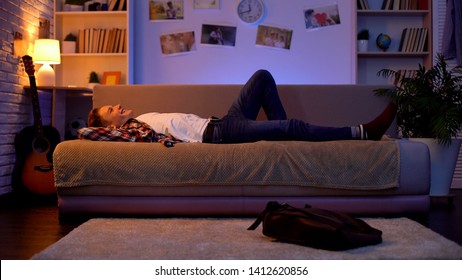 Satisfied Smiling Teenager Student Coming Home, Lying Down On Sofa, First Job