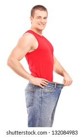 A Satisfied Weight Loss Man In A Pair Of Old Jeans Isolated On White Background