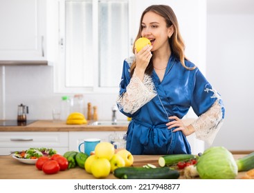 Satisfied Woman In Dressing Gown Eating Apples