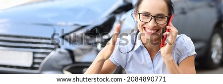 Satisfied woman talking on mobile phone near wrecked car. Profitable car insurance concept