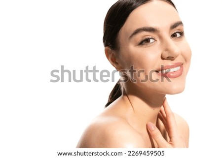 satisfied young woman with bare shoulders looking at camera isolated on white