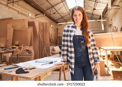 Satisfied Young Woman As A Carpenter Apprentice In The Carpentry Workshop