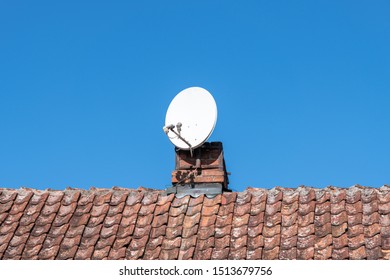 Sattelite Dish On Old Clay Tile Roof.