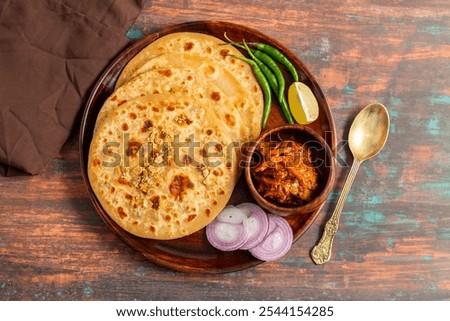 Sattu paratha, a nutritious flatbread from Uttar Pradesh and Bihar, stuffed with roasted gram flour, served with pickle and raita.