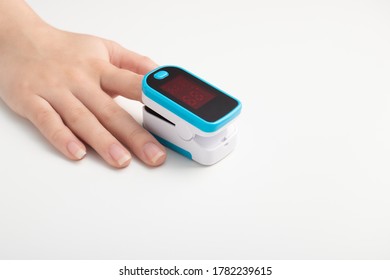 Saturation Of Hemoglobin Of Blood With Oxygen. Female Finger In A Pulse Oximeter