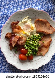 Saturday Brunch With Bacon, Ham, Egg, Green Peas And Tomatos